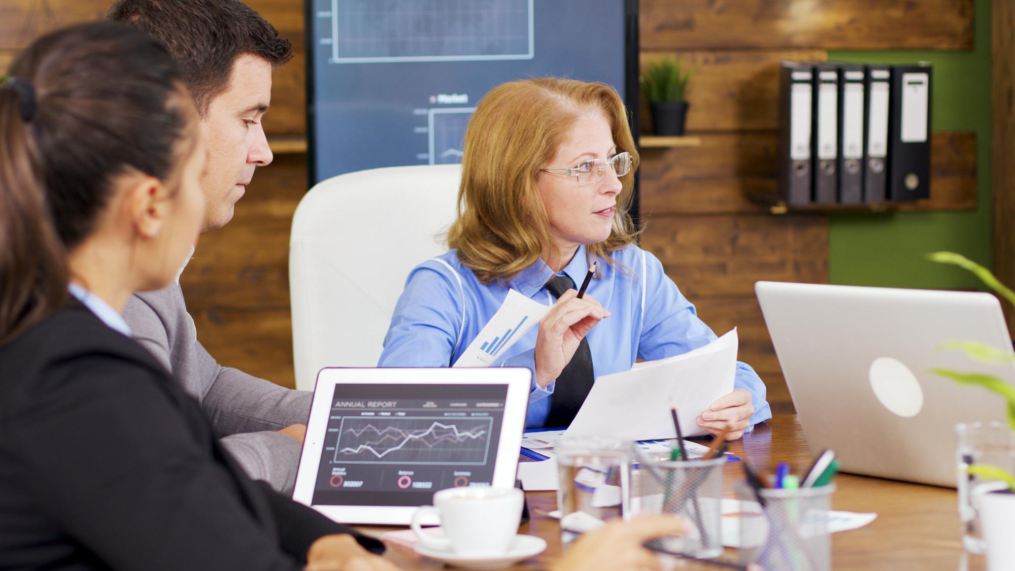 Advisor discussing stock charts with client